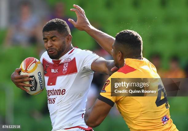 Kallum Watkins of England fends off a tackle during the 2017 Rugby League World Cup Quarter Final match between England and Papua New Guinea Kumuls...