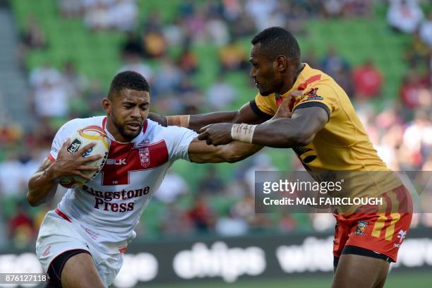 England Kallum Watkins is tackled by Kato Ottio of Papua New Guinea during their Rugby League World Cup quarter-final match between England and Papua...