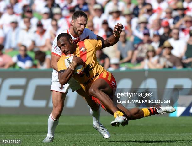 Englands Luke Gale tackles Stargroth Amean of Papua New Guinea during their Rugby League World Cup quarter-final match between England and Papua New...