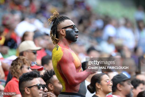 Supporter watches the Rugby League World Cup quarter-final match between England and Papua New Guinea in Melbourne on November 19, 2017. / AFP PHOTO...