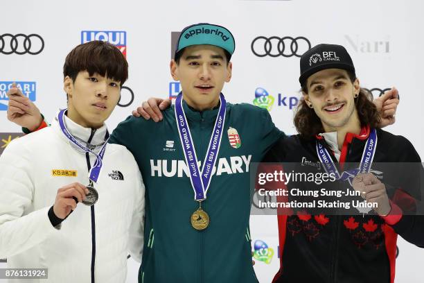 Second place Hwang Dae-Heon of South Korea, first place Shaolin Sandor Liu of Hungary and third place Samuel Girard of Canada celebrate during the...