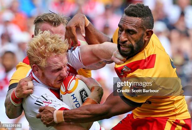 James Graham of England is tackled by Moses Meninga of the Kumuls during the 2017 Rugby League World Cup Quarter Final match between England and...