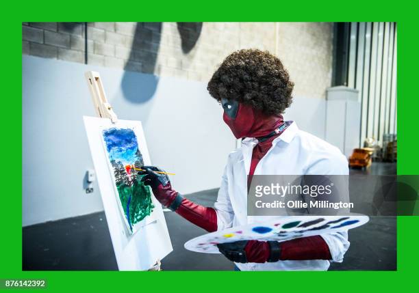 Bob Ross Deadpool cosplayer painting in character during the Birmingham MCM Comic Con held at NEC Arena on November 18, 2017 in Birmingham, England.