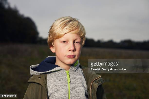 child stood in a field - serious child stock pictures, royalty-free photos & images