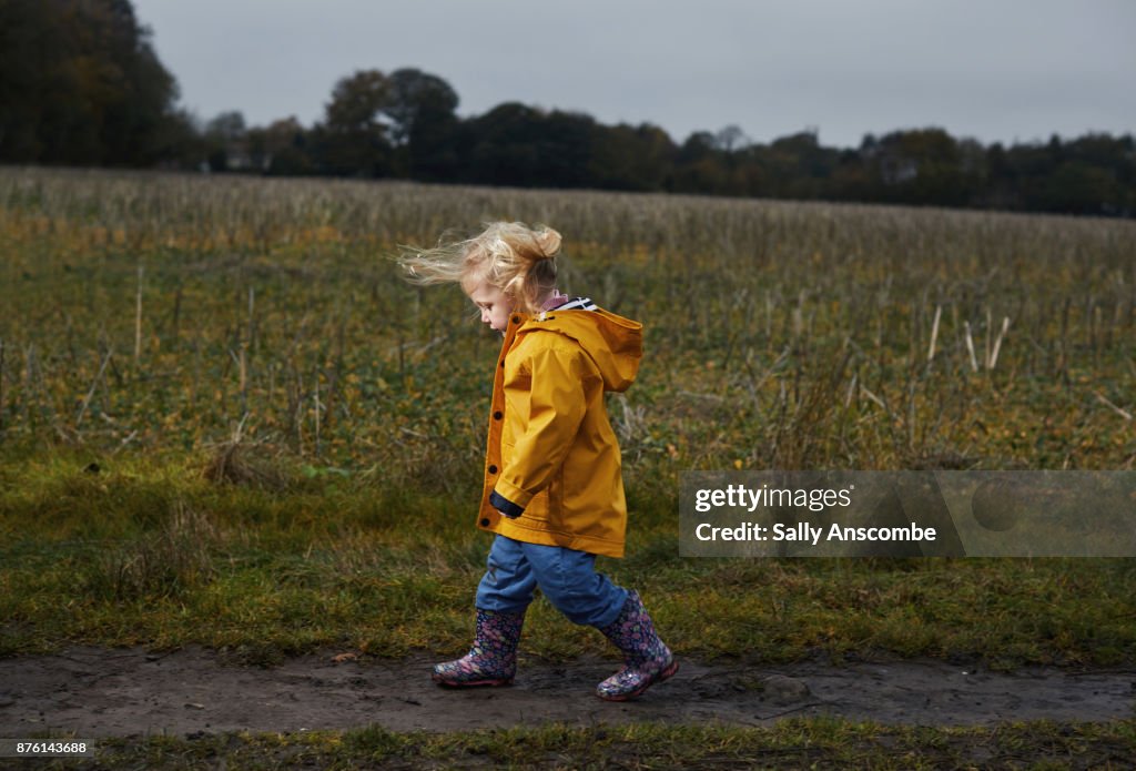 Child walking through a field
