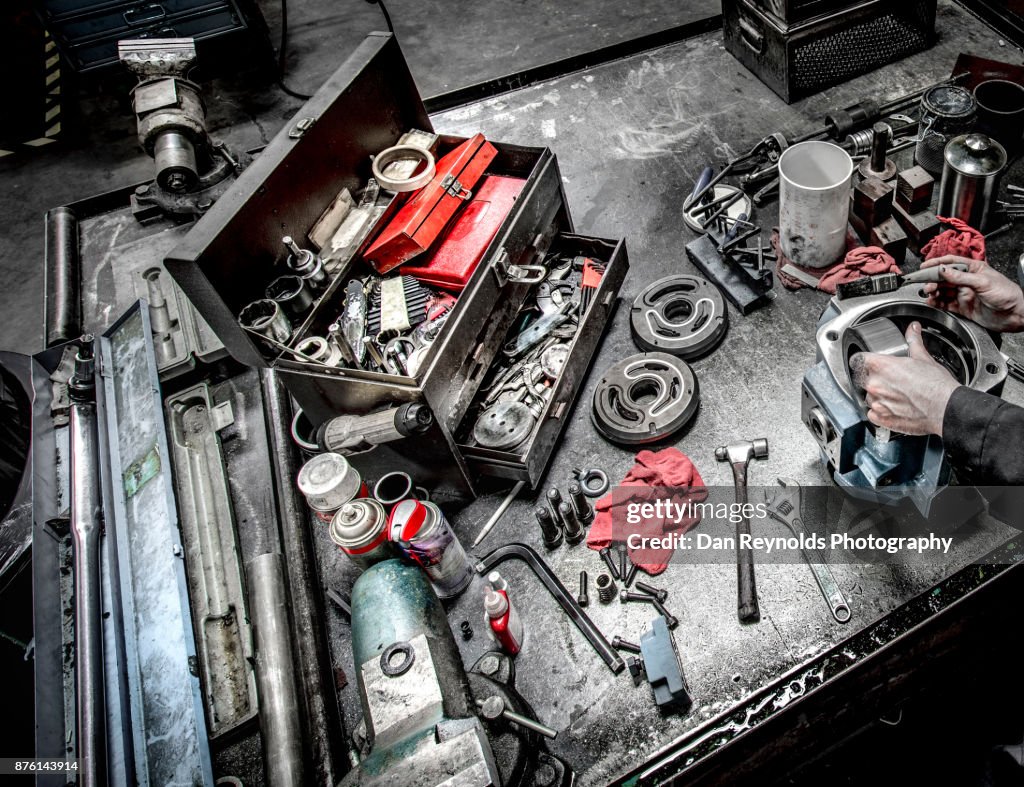Man with Tools on Industrial Workbench