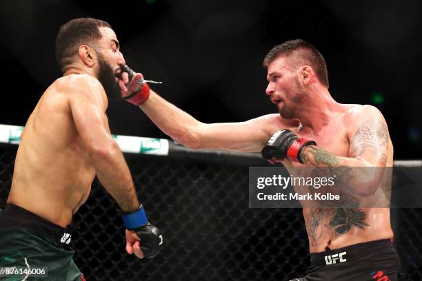 Tim Means of the USA punches Belal Muhammad of the USA in their welterweight bout during the UFC Fight Night at Qudos Bank Arena on November 19, 2017...