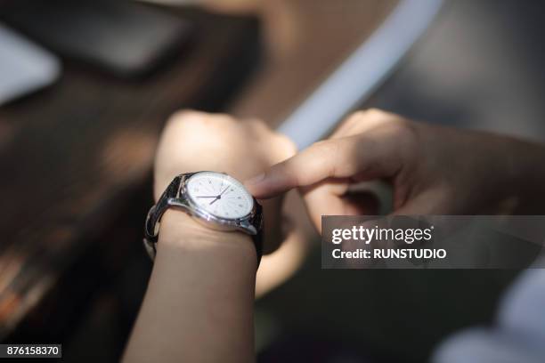 close-up of businessman outdoors checking the time - ver as horas imagens e fotografias de stock