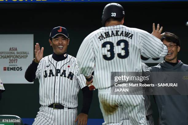 Infielder Hotaka Yamakawa of Japan celebrates with Head coach Atsunori Inaba after scoring a run to make it 1-0 by the RBI double of Infielder Shuta...