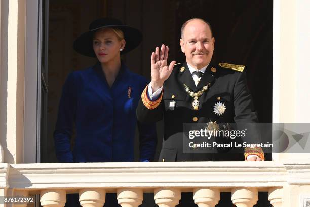 Princess Charlene of Monaco and Prince Albert II of Monaco greet the crowd from the palace's balcony during the Monaco National Day Celebrations on...