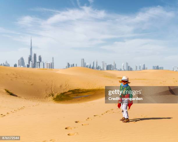 the child walking in the desert - dubai skyline daytime stock pictures, royalty-free photos & images