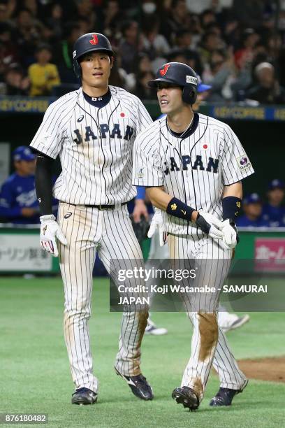 Infielder Shuta Tonosaki of Japan celebrates after scoring a run to make it 4-0 with Outfielder Seiji Uebayashi after the two run double by Infielder...