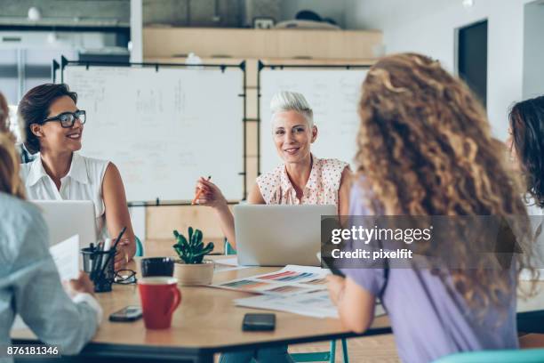 team of female professionals on a meeting - outsourcing stock pictures, royalty-free photos & images