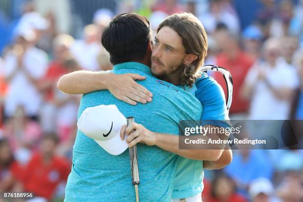 Kiradech Aphibarnrat of Thailand embraces Tommy Fleetwood of England on the 18th green during the final round of the DP World Tour Championship at...