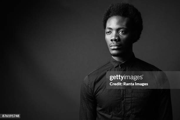 black and white portrait of young handsome african man - monochrome 700063863 stock pictures, royalty-free photos & images