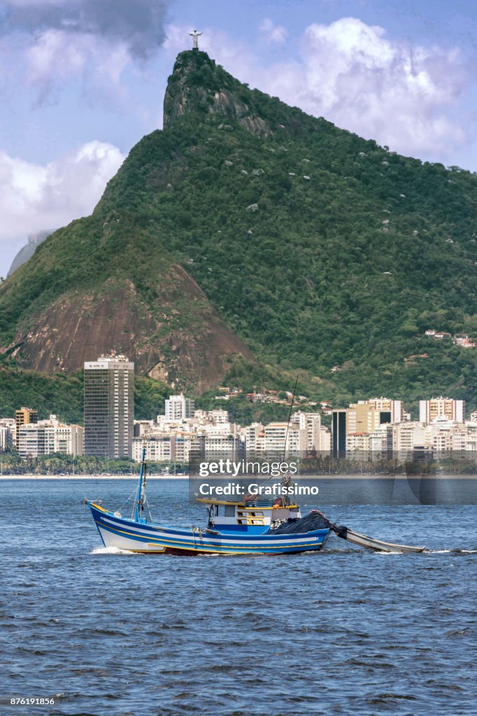 Fishing boat in Guanabara Bay in front of Christ the Redeemer
