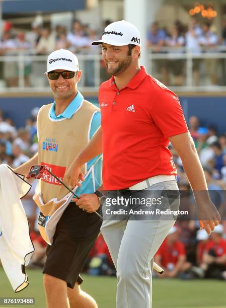 Jon Rahm of Spain reacts on the 18th green with his caddie Adam Hayes during the final round of the DP World Tour Championship at Jumeirah Golf...