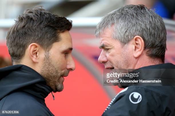 Friedhelm Funkel, head coach of Duesseldorf talks to Stefan Leitl , head coach of Ingolstadt prior to the Second Bundesliga match between FC...