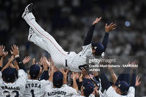 Head coach Atsunori Inaba of Japan is tossed into the air after the Eneos Asia Professional Baseball Championship 2017 final game between Japan and...