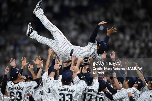 Head coach Atsunori Inaba of Japan is tossed into the air after the Eneos Asia Professional Baseball Championship 2017 final game between Japan and...