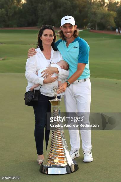 Tommy Fleetwood of England poses with the Race to Dubai trophy, partner Clare Craig and son Franklin during the final round of the DP World Tour...
