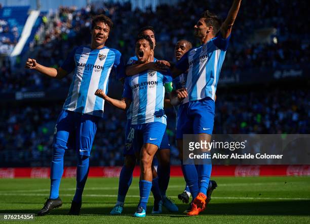 Roberto Rosales of Malaga CF celebrates after scoring the first goal for Malaga CF with Adalberto Penaranda of Malaga CF and Adrian Gonzalez of...