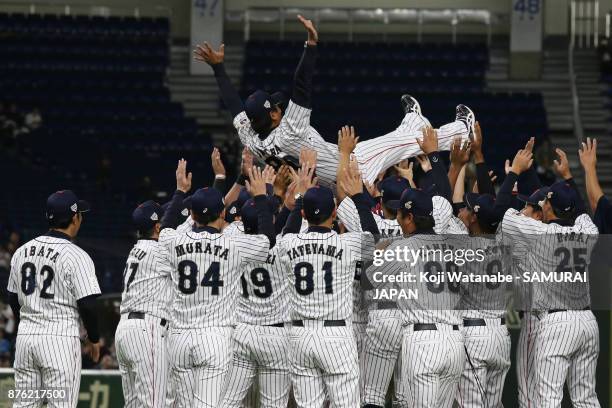 Head coach Atsunori Inaba of Japan is thrown into the air after the Eneos Asia Professional Baseball Championship 2017 final game between Japan and...