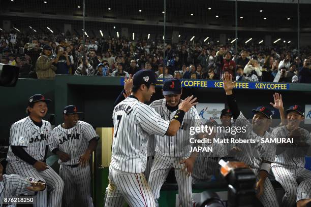 Infielder Shuta Tonosaki of Japan high fives with team mates after awarded the most valuable player after the Eneos Asia Professional Baseball...