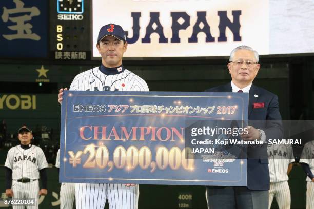 Head coach Atsunori Inaba of Japan poses for photographs with the Nippon Professional Baseball Commissioner Katsuhiko Kumazaki at the award ceremony...