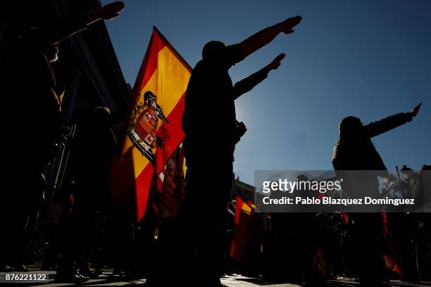 Supporters of Franco do a fascist salute as one holds a pre-constitutional Spanish flag during a rally commemorating the 42nd anniversary of Spain's...
