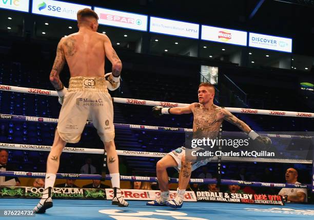 Gary Cully knocks Kane Baker to the floor during their Lightweight bout on the Frampton Reborn boxing bill at SSE Arena Belfast on November 11, 2017...