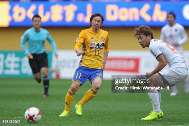 Naoki Ishihara of Vegalta Sendai takes on Kazuma Takayama of Omiya Ardija during the J.League J1 match between Vegalta Sendai and Omiya Ardija at...