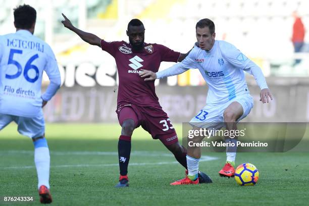 Nicolas N koulou of Torino FC is challenged by Valter Birsa of AC Chievo Verona during the Serie A match between Torino FC and AC Chievo Verona at...