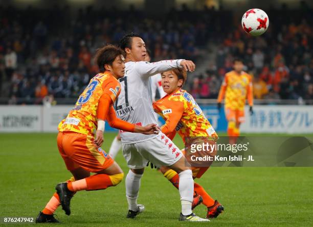 Takuma Arano of Consadole Sapporo competes for the ball against Koya Kitagawa and Shota Kaneko of Shimizu S-Pulse during the J.League J1 match...