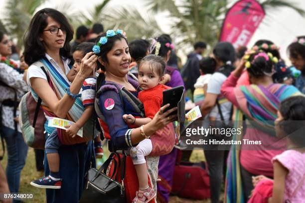 Women with their babies participate in Baby-Wearing Super Moms event organised by by Colors Pinkathon at Juhu Beach, Juhu, on November 18 2017 in...