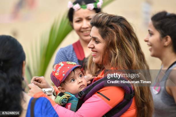 Women with their babies participate in Baby-Wearing Super Moms event organised by by Colors Pinkathon at Juhu Beach, Juhu, on November 18 2017 in...