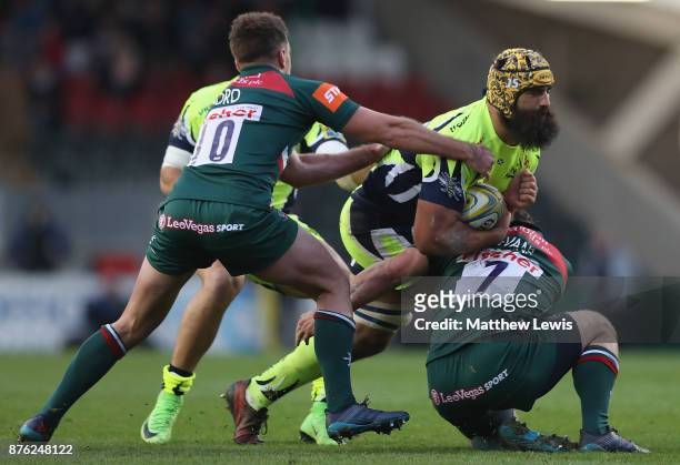 Will Evans of Leicester Tigers tackles Josh Strauss of Sale Sharks during the Aviva Premiership match between Leicester Tigers and Sale Sharks at...