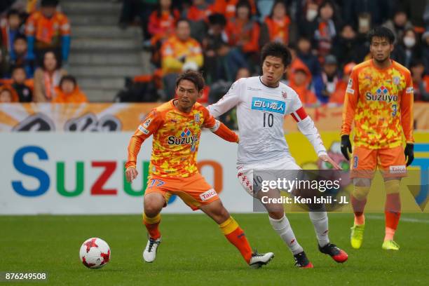 Shota Kaneko of Shimizu S-Pulse and Hiroki Miyazawa of Consadole Sapporo compete for the ball during the J.League J1 match between Shimizu S-Pulse...