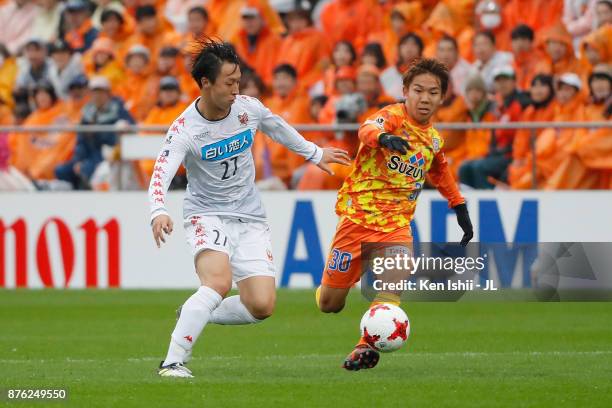 Shota Kaneko of Shimizu S-Pulse and Takuma Arano of Consadole Sapporo compete for the ball during the J.League J1 match between Shimizu S-Pulse and...
