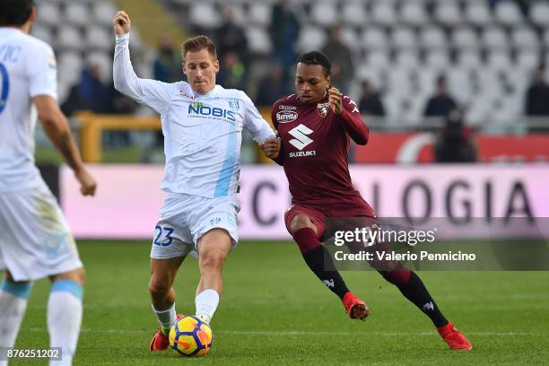 Joel Obi of Torino FC competes with Valter Birsa of AC Chievo Verona during the Serie A match between Torino FC and AC Chievo Verona at Stadio...