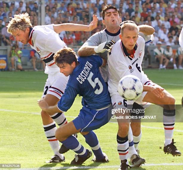 Italian defender Alessandro Costacurta and goalkeeper Gianluca Pagliuca is challenged by Norwegians Vidar Riseh and Stale Solbakken 27 June at the...