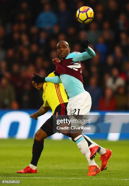 Angelo Ogbonna of West Ham United battles with Andre Gray of Watford during the Premier League match between Watford and West Ham United at Vicarage...