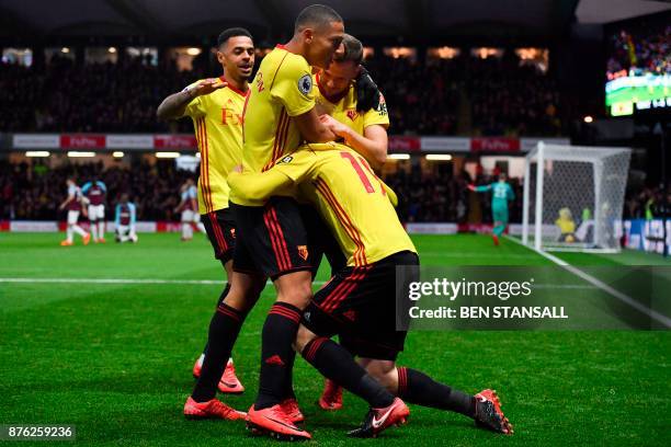 Watford's English midfielder Will Hughes celebrates scoring the opening goal with team-mates during the English Premier League football match between...