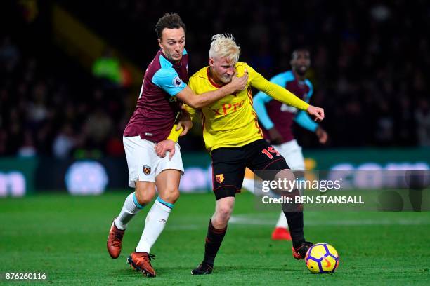 West Ham United's English midfielder Mark Noble challenges Watford's English midfielder Will Hughes during the English Premier League football match...