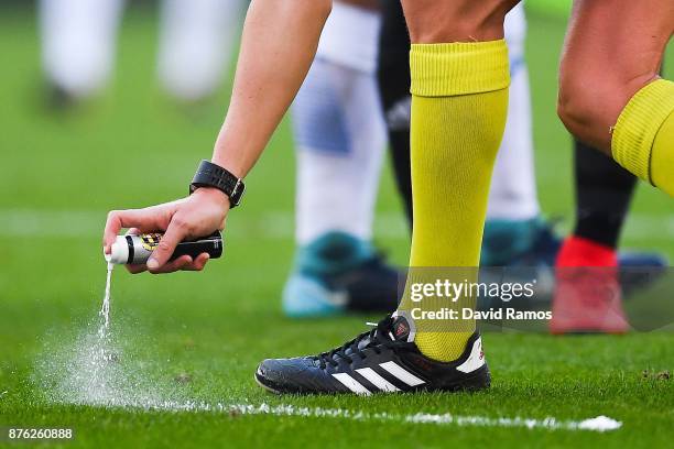 The referee uses vanishing spray during the La Liga match between Espanyol and Valencia at Cornella - El Prat stadium on November 19, 2017 in...