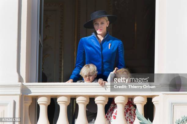 Princess Charlene of Monaco with Prince Jacques of Monaco, and Princess Gabriella of Monaco greet the crowd from the Palace's balcony during the...