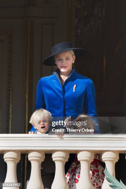 Princess Charlene of Monaco with Prince Jacques of Monaco, and Princess Gabriella of Monaco greet the crowd from the Palace's balcony during the...