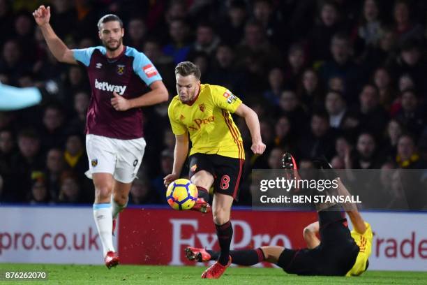 Watford's Brazilian striker Richarlison de Andrade goes down after being pushed in the back by West Ham United's English striker Andy Carroll , an...