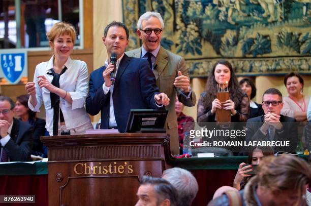 French actress Julie Depardieu, French radio and TV host Marc-Olivier Fogiel and French auctioneer Francois De Ricqles conduct the 157th charity wine...