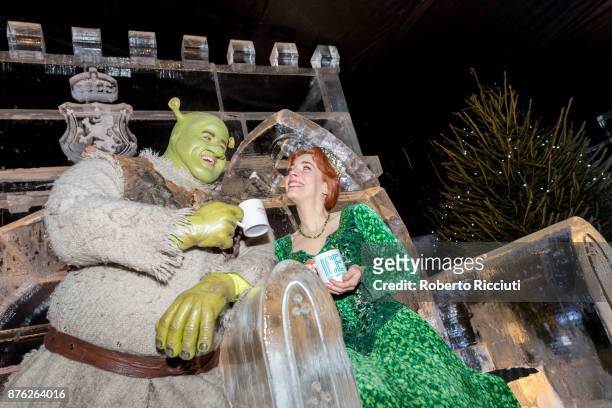 Steffan Harrs, performing as Shrek, and Laura Main, performing as Fiona, attend a photocall at Ice Adventures during 'Light Night', the event that...